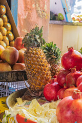 Berna Bugh, Kangan, India. Pomegranates, pineapple and apples at a market.