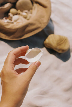 A woman holding a seashell 