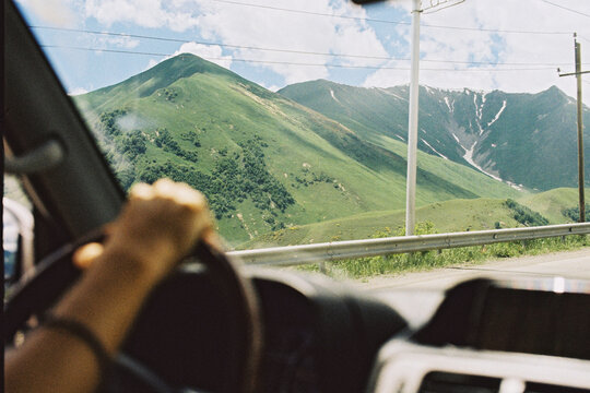 A panoramic view of the mountains seen through the car window