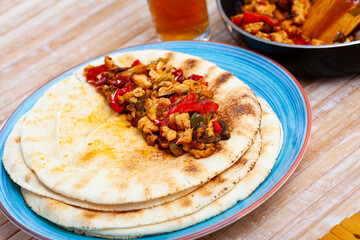 Roasted chopped chicken with vegetables on pita, food preparation