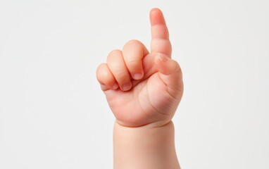 A childs hand with chubby fingers pointing upward, isolated on a clean white background