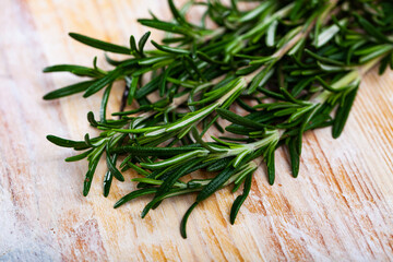 Image of rosemary on wooden background, top view