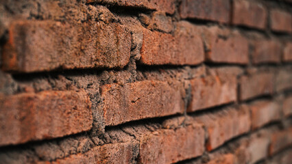 Red brick wall from the side, focus selected, blur on the far side
