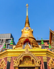 Fototapeta premium Colorful golden Chedi Pagoda, Wat Thatsanarun Suntharikaram community temple, Bangkok, Thailand. Small old temple in a neighborhood in Bangkok.