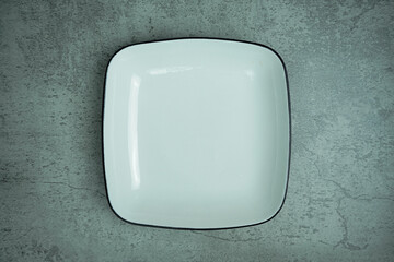 Empty Square Plate on the grey background. Top view.