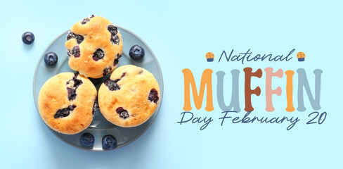 Plate with tasty blueberry muffins on blue background