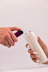 Hands lighting a white candle