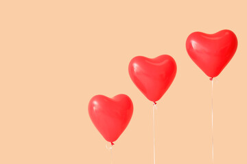 Heart-shaped balloons on beige background. Valentine's Day celebration