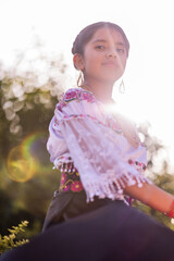 Latin american girl wearing traditional clothes celebrating national festivities.