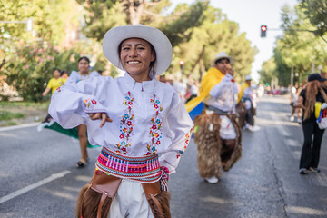Hispanic woman dancing cayambe in traditional clothes during columbus day parade. Dia hispanidad