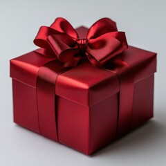 Obraz premium Red Gift Box with Satin Bow on White Background for Celebrations and Holidays