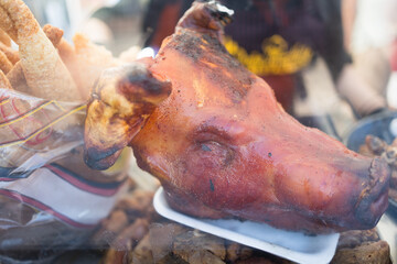 Roasted pig head displayed during hispanicity day parade. Dia de la hispanidad