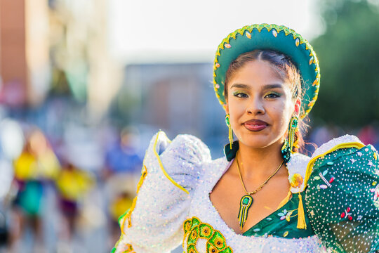 Colombian woman wearing traditional Caporales clothing during parade celebrating hispanic culture. 