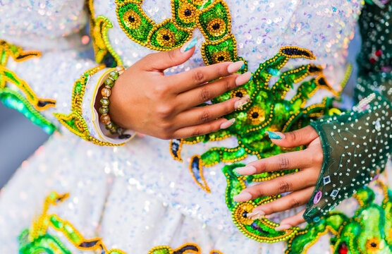 Dancer showing traditional bolivian caporales dress and manicure during hispanic day parade