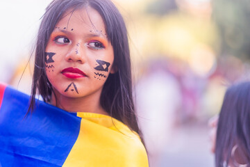 Young girl celebrating national holiday with traditional Shuar face paint Dia de la hispanidad