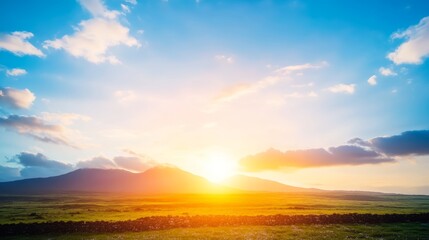 Fototapeta premium Serene Sunset Over Rolling Green Hills and Distant Mountains