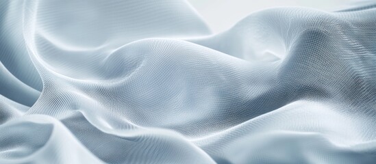 Fototapeta premium Soft, flowing light blue fabric with subtle texture and gentle folds.