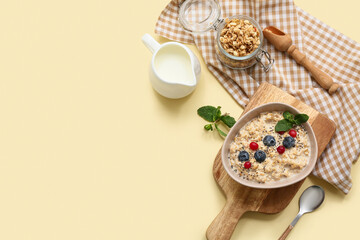 Composition with napkin, tasty oatmeal and berries on beige background