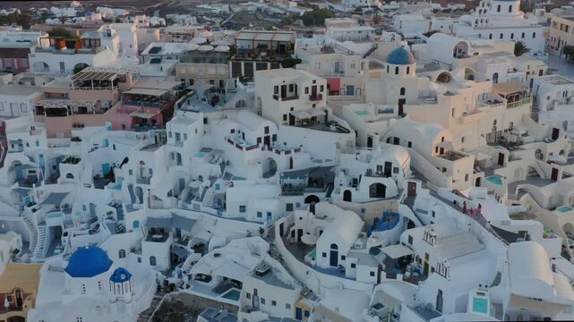 Aerial view of Oia town and Santorini island on a foggy morning at sunrise, Santorini, Greece