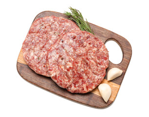 Wooden cutting board with raw meat cutlets isolated on white background