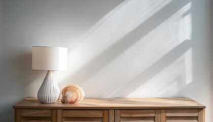 Empty White Wall Mockup in Coastal Interior with Wooden Console Table with a Seashell Lamp. Natural Daylight From a Window. Promotion Background.