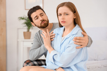 Fototapeta premium Young woman refusing to forgive her husband in bedroom