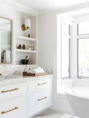 Modern bathroom with sleek cabinet, ample storage, and natural light