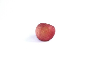 A Fuji apple, or Malus pumila, or Malus domestica on a white background. This apple has a yellowish-red skin color and a sweet honey flavor.