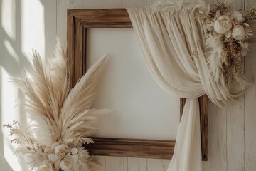 A minimalistic decor featuring a wooden frame draped with fabric, complemented by dried flowers and pampas grass, creating a soft, elegant atmosphere.