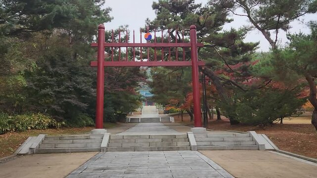 Front view of Hongsalmun Gate with pine trees against Chunguimun Gate of Hyeonchungsa Shrine