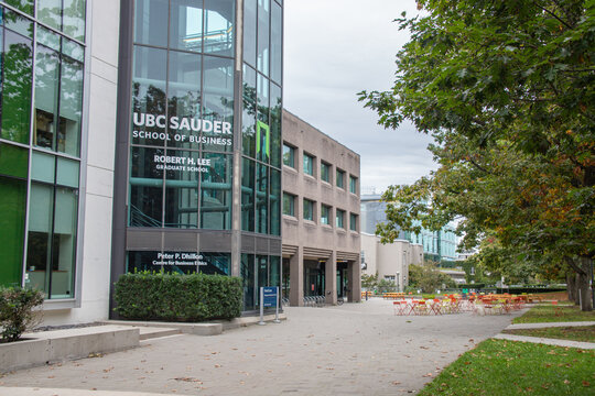 Vancouver, CANADA - Sep 30 2024 : Modern exterior view of the UBC Sauder School of Business, featuring large glass windows, outdoor seating, and surrounding greenery on campus.