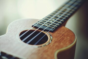 Obraz premium Closeup view of a wooden ukulele soundhole and strings