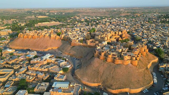 A straight forward drone shot of Jaisalmer Fort and the surrounding Rajasthan cityscape on a sunny day India 4K