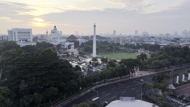 Surabaya, East Java, Indonesia stock drone video - Slow moving aerial footage of the city of Surabaya near the Heroes Monument filmed in HDR at dawn