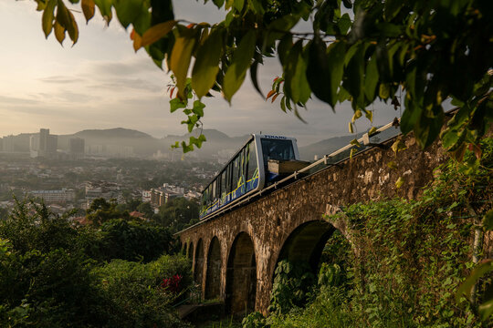 Penang, Malaysia - December 3 2024 : A funicular train going up carrying passengers to the famous Penang Hill at Ayer Itam, Penang.