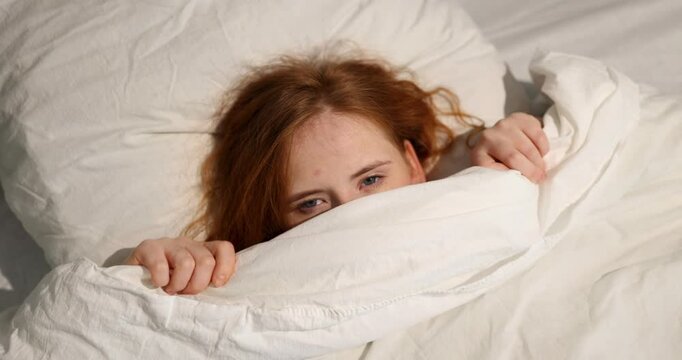 A person wraps themselves snugly in a cozy, warm blanket, conveying deep emotions of comfort, safety, and avoidance
