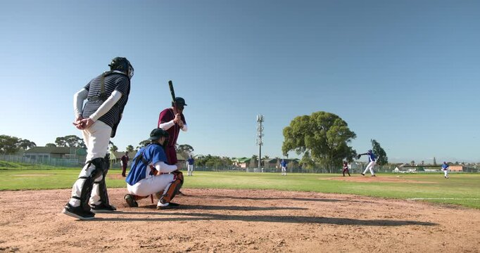 Playing baseball, catcher and batter waiting for pitch on sunny field