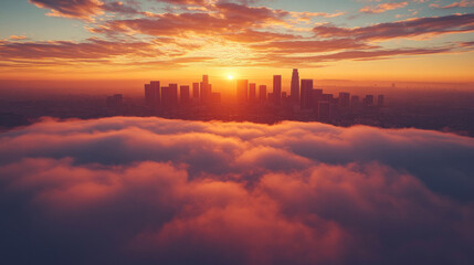 Los Angeles skyline at sunrise, with fog gently covering the lower buildings and hills