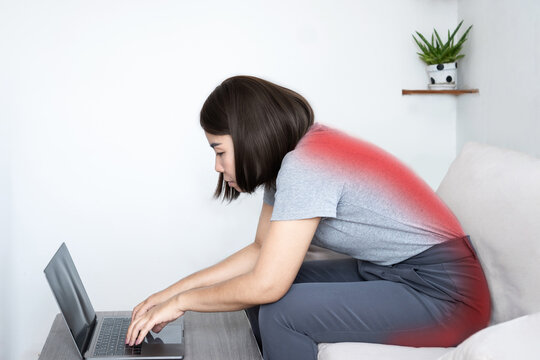 slouching position concept with Asian woman hunching her back at  computer desk and sitting in bad posture