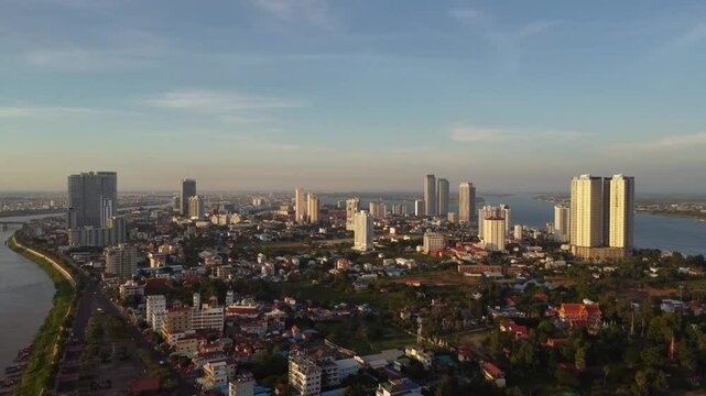 Drone view of infrastructure development on Tonle sap river, Commercial office and residential highrise buildings alongside the river, Phnom Penh city