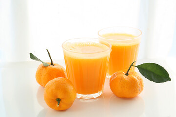 orange color tangerines and fresh juice isolated on a white background