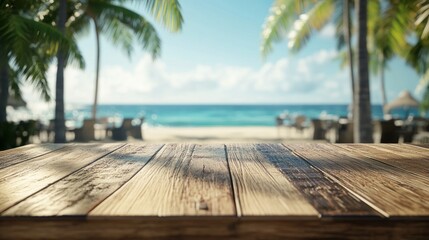 Empty wood table in a beach café with sunlight, blurred ocean view, and a relaxed atmosphere.