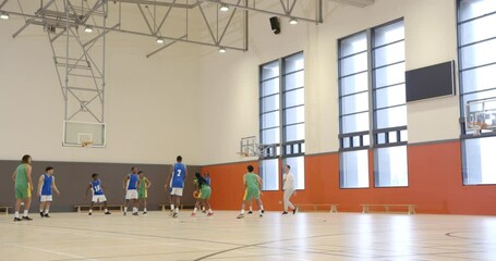 Playing basketball in gym, students practicing game with coach in school - Powered by Adobe