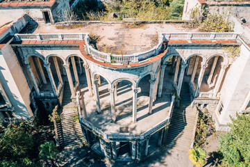 Abandoned sanatorium Tskaltubo Georgia showing crumbling architecture, overgrown courtyards,...