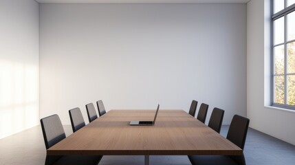 Laptop sitting on a large wooden conference table in a modern office space