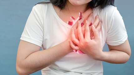 heart disease concept. woman pressing on chest with painful expression. severe heartache and having...