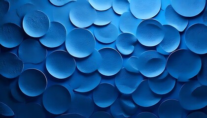 Overlapping blue circles with raised centers form a textured, scale-like pattern.