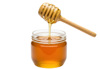 A jar of golden honey with a wooden dipper resting on top, honey dripping from the dipper, isolated on white background