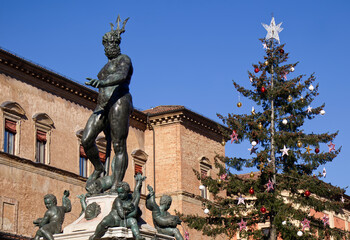 Neptune statue and Christmas tree in Piazza Nettuno. Bologna Italy.