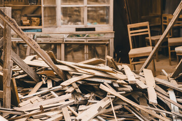 Pile of wood waste old garbage from furniture factory. Reused or recycled wood board plank.